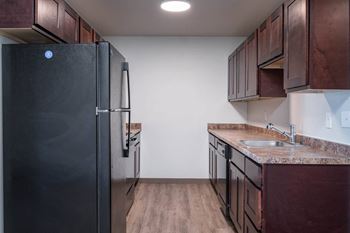 Fully-equipped kitchen with refrigerator, oven/stove, microwave, and dishwasher.